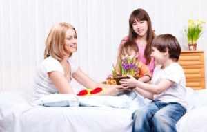 Son presenting flowers to mother